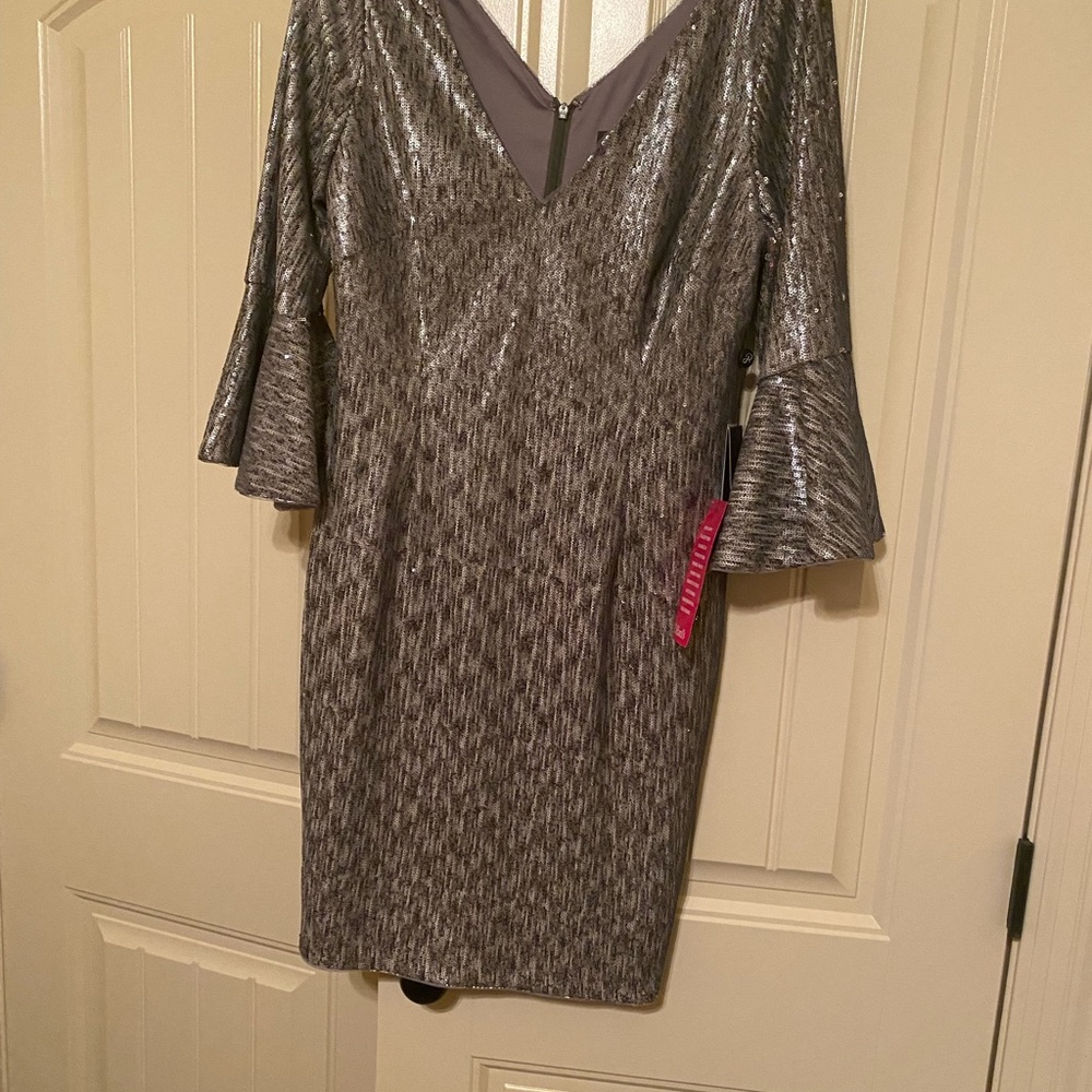 Silver/gray sequin dress with V-neck and bell sleeves.